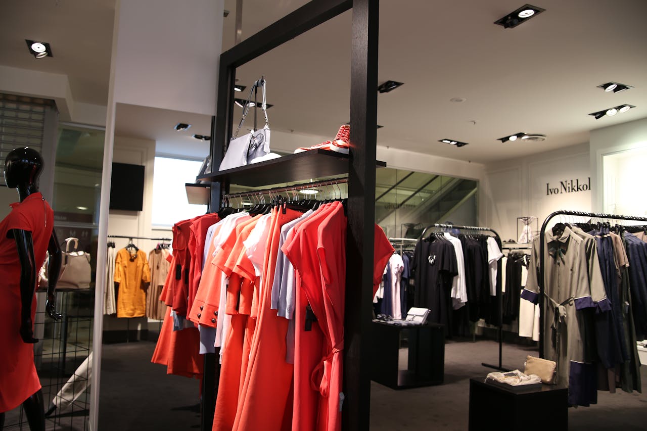 about-img Discover a chic fashion boutique showcasing a variety of colorful clothes on elegant racks.